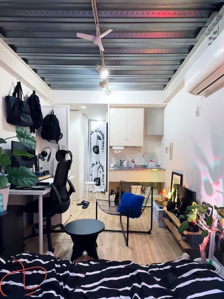 Modern black and white 6-tatami studio apartment featuring a desk and office chair with a workspace for remote work