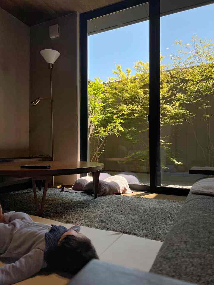 Natural tone living room featuring a floor lamp, coffee table, and sofa with a cozy interior atmosphere