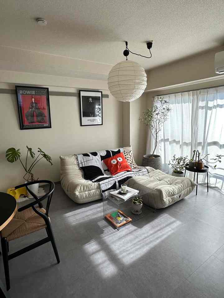 Beige toned living room featuring Ligne Roset sofa and plants with a natural, cozy atmosphere