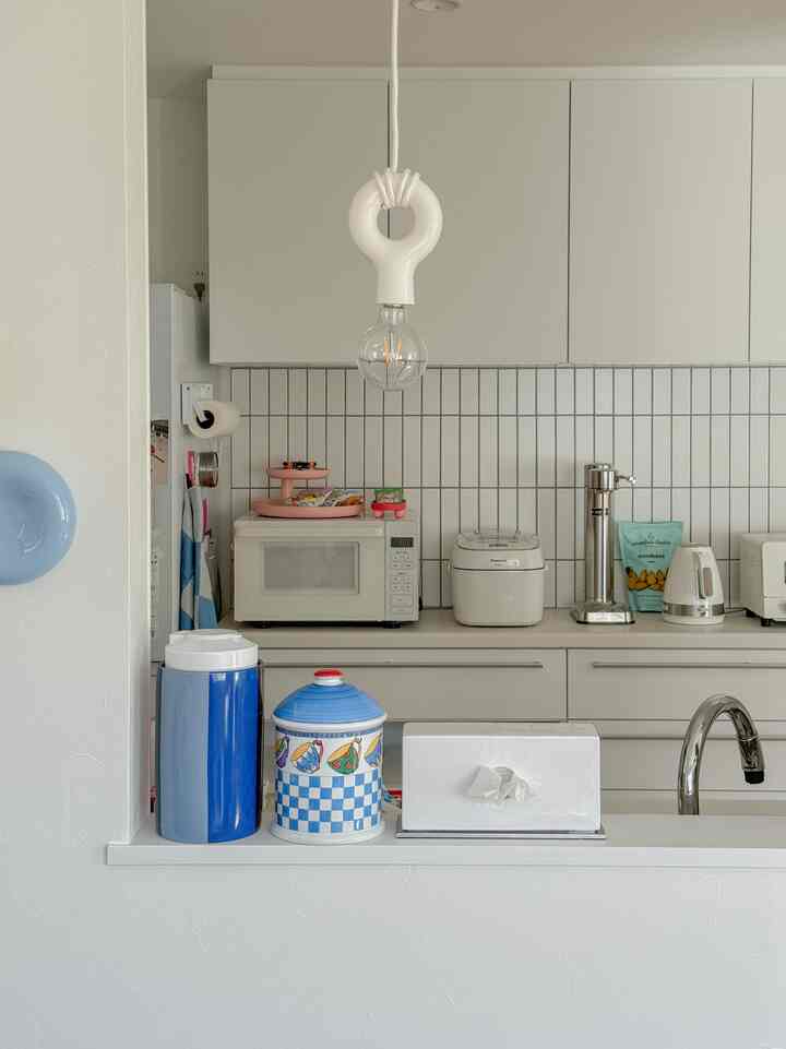 白を基調としたキッチン、中央に電子レンジと回転トレイが置かれたモダンで清潔感のあるインテリア