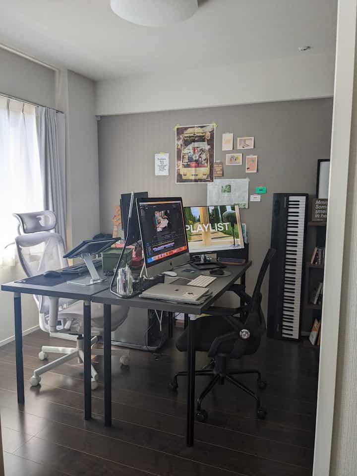 White and black toned compact home office featuring two modern desks and office chairs in a practical workspace