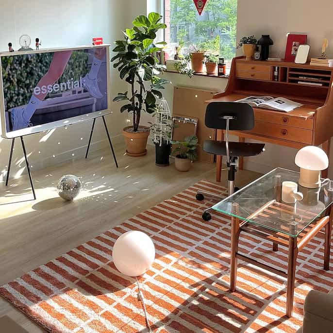 Creating a chic space with a disco ball and colorful rug. #DiscoDecor #ColorfulVibes #ChicInteriors