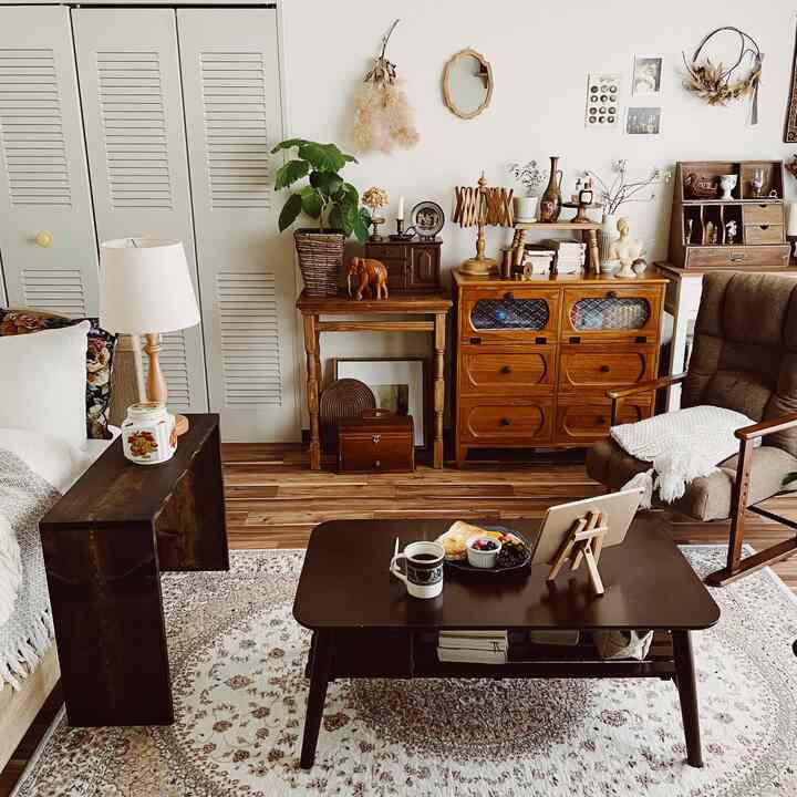 Brown and white toned living room featuring vintage furniture, side table, and coffee table creating a cozy atmosphere