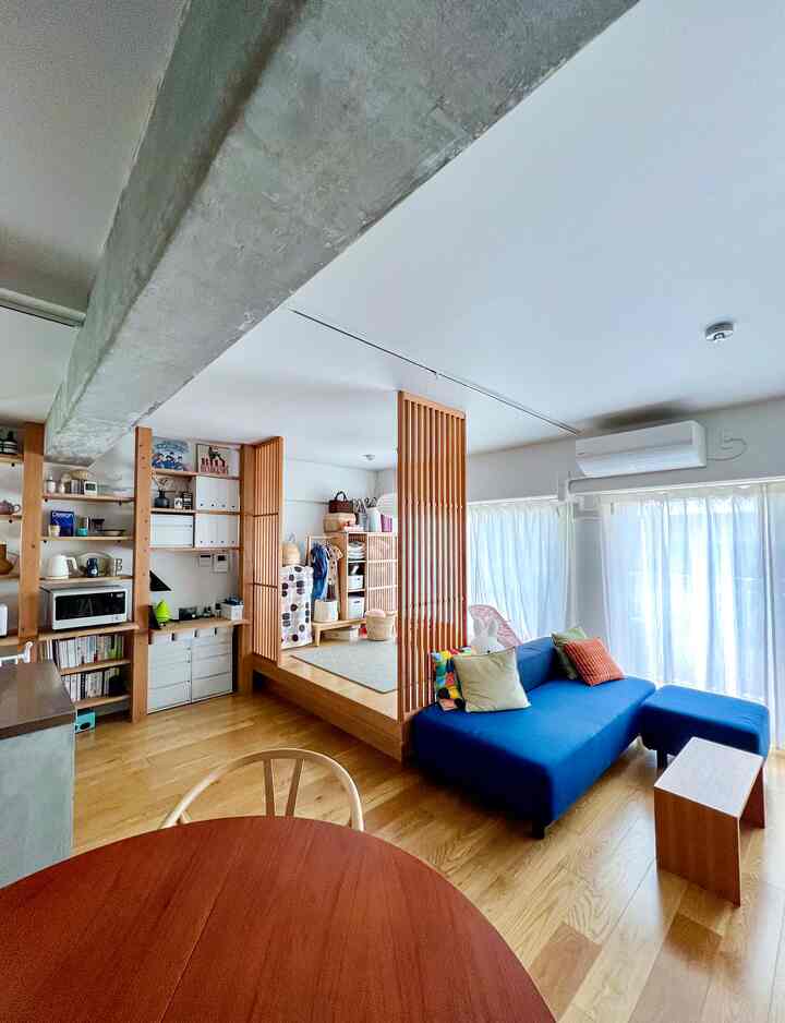 ナチュラルカラーとブルーソファが調和した北欧風リビング、収納とレイアウトが印象的な居心地の良い空間