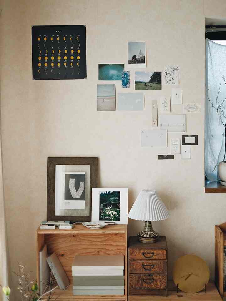 Calm beige-toned natural space featuring wooden storage units and diverse wall decor creating a cozy atmosphere