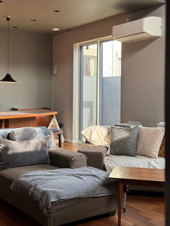 Natural brown-toned living room featuring a sectional sofa and coffee table with a cozy, modern atmosphere