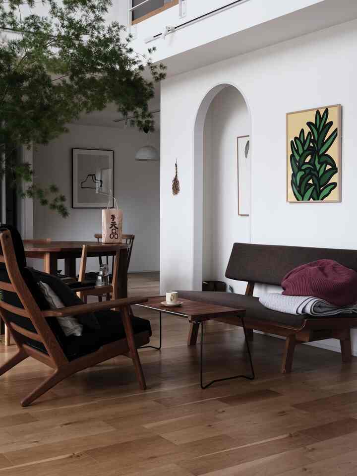 Natural wood tone living room with white walls, featuring modern sofas and a coffee table in a simple setting