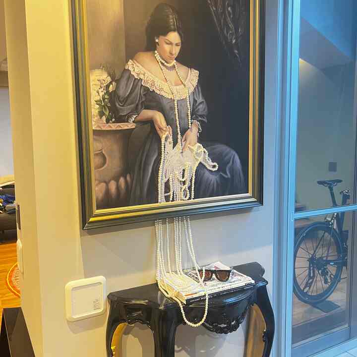 Ivory pearl décor with black console table in entrance featuring classic framed art creating elegant atmosphere