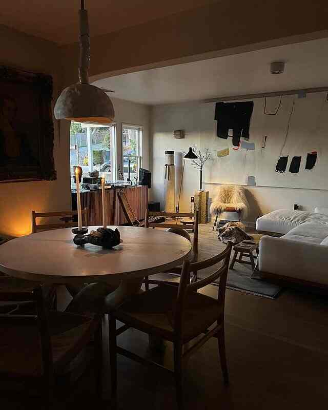Cozy natural modern living room with warm brown and white tones, featuring wooden furniture and a white sectional sofa with ambient lighting