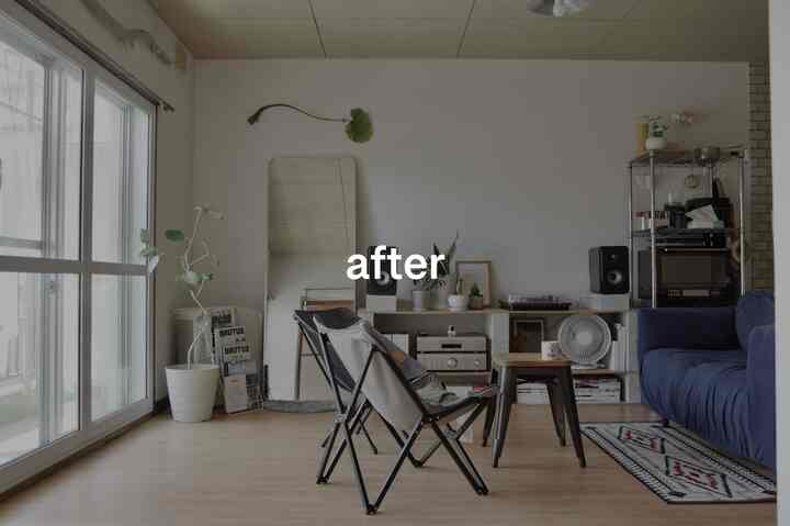 Natural-toned living room with white walls, DIY shelving and blue sofa in a simple, tidy setup