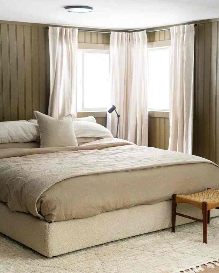 Beige-toned bedroom featuring large bed and curtains in a cozy natural modern style space