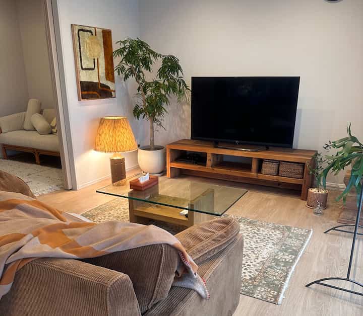 Natural brown-toned living room featuring sofa and table lamp with a cozy atmosphere