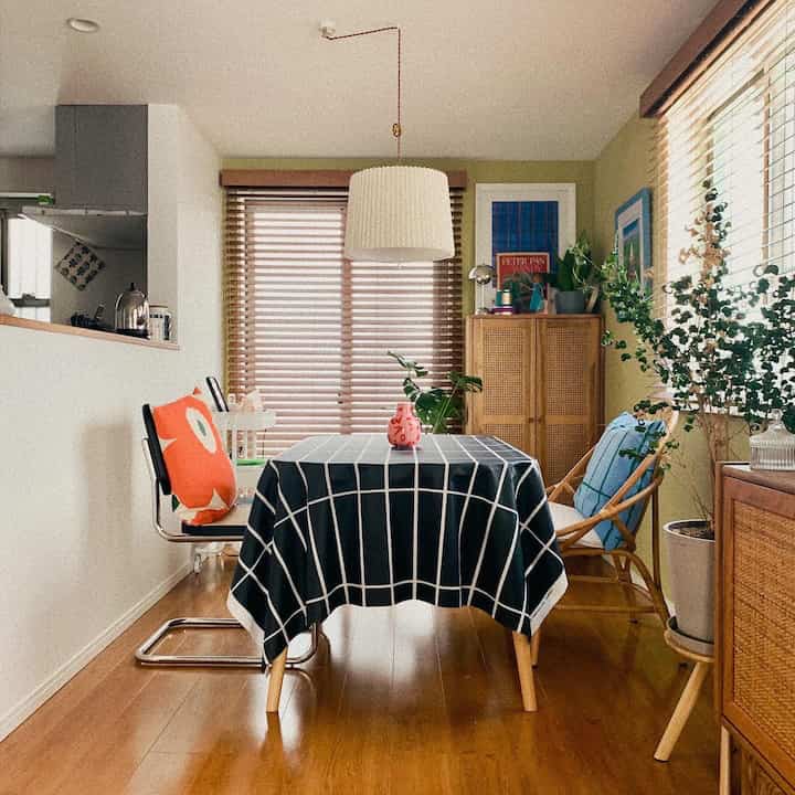 Natural-toned Nordic dining room featuring wooden furniture and checkered tablecloth creating a cozy atmosphere