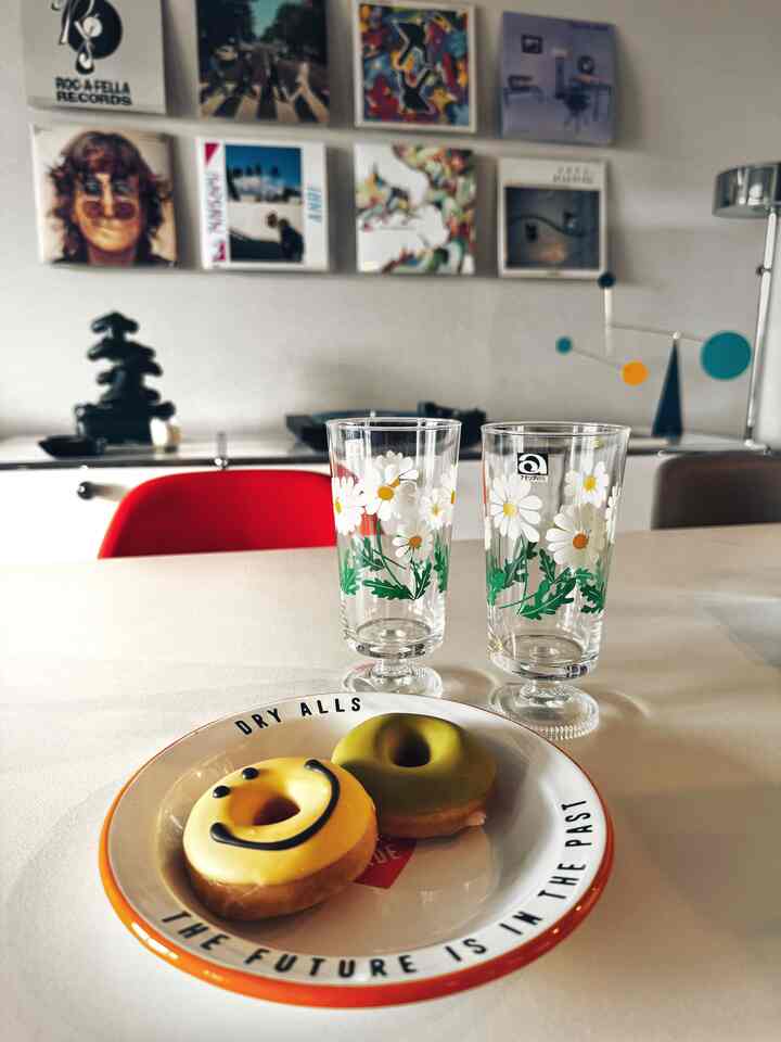 White-toned dining table featuring Adelia Retro floral glasses and donuts in a retro style home cafe setting