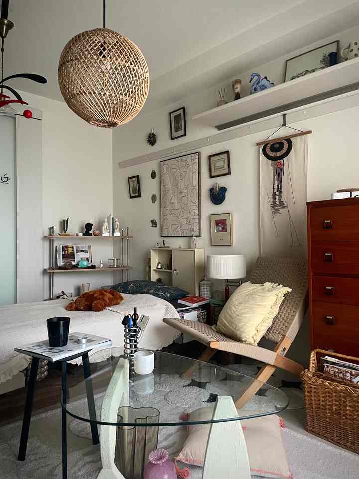 Natural-toned small bedroom featuring vintage-style furniture and cozy accessories with a warm atmosphere