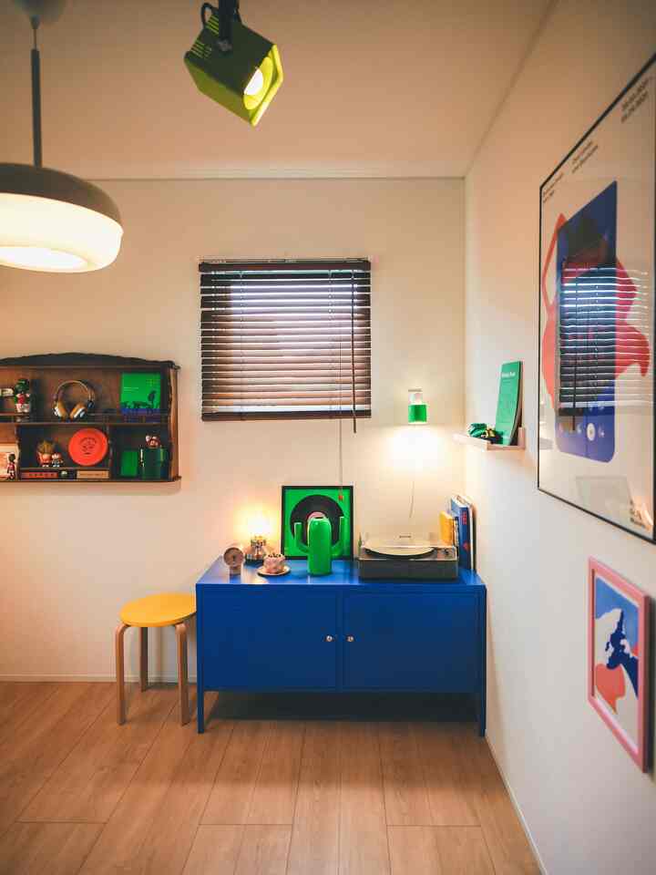 Cozy workspace with bright blue cabinet, wood-tone flooring, and green accents creating a vibrant atmosphere