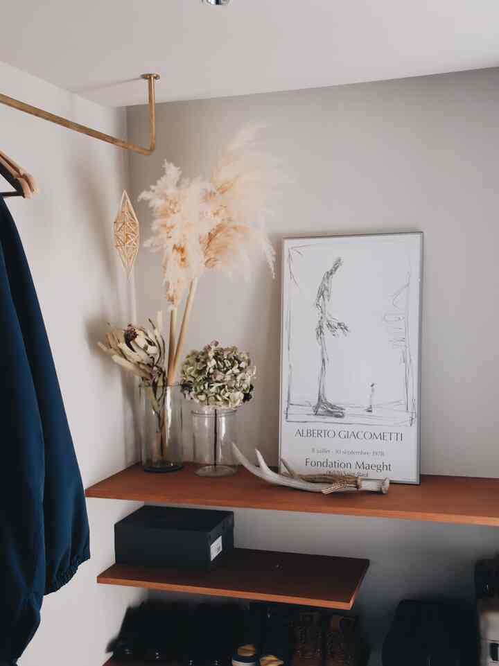 Natural-toned entrance space featuring brown shelves and a coat rack, creating a cozy atmosphere