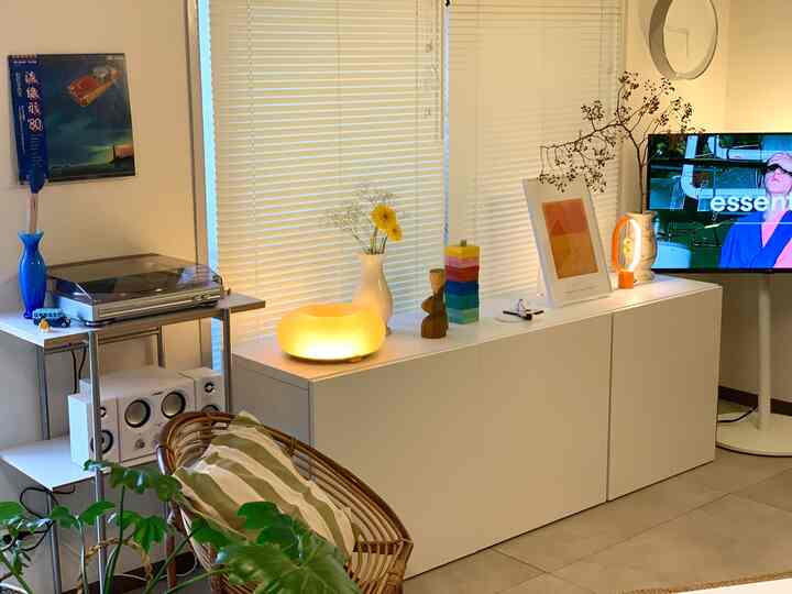 Nordic style living room with white and wood tones featuring a white BESTÅ cabinet adorned with various lamps and decor creating a cozy atmosphere
