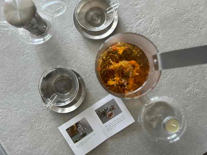A calm home cafe table scene featuring clear glass teacups and teapot in bright natural tones