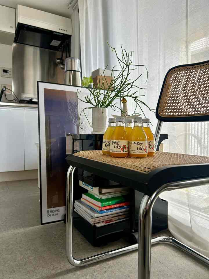 Natural-toned studio kitchen space featuring a Cesca chair and Bauhaus poster with a neat interior