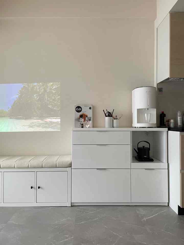White toned kitchen space featuring storage cabinet and minimalistic design with clean and neat atmosphere