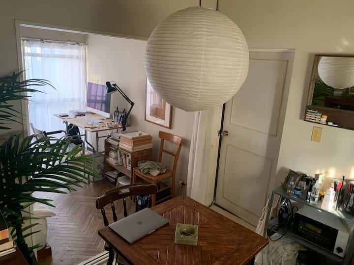 White and wood tone single household kitchen dining space featuring a home office with natural modern style, creating a cozy atmosphere