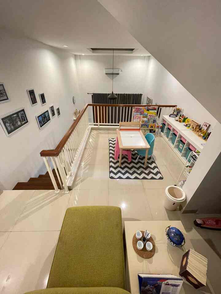 White and gray toned loft kids' playroom featuring child-sized table and storage units in a tidy layout