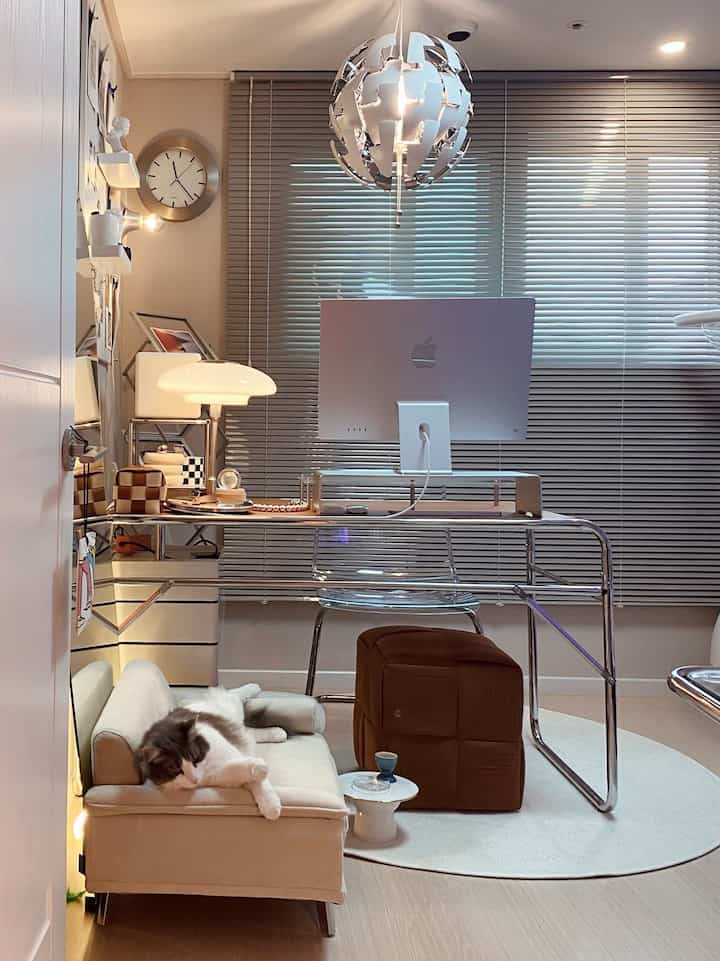 White and brown toned home office space featuring a cat sofa and neat desk arrangement, creating a cozy interior