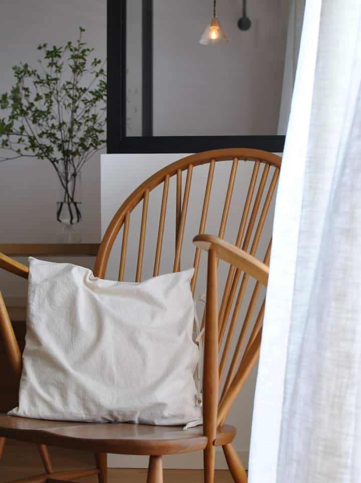 Natural-toned living room featuring a natural modern Ercol lounge chair with cushion in a cozy setting