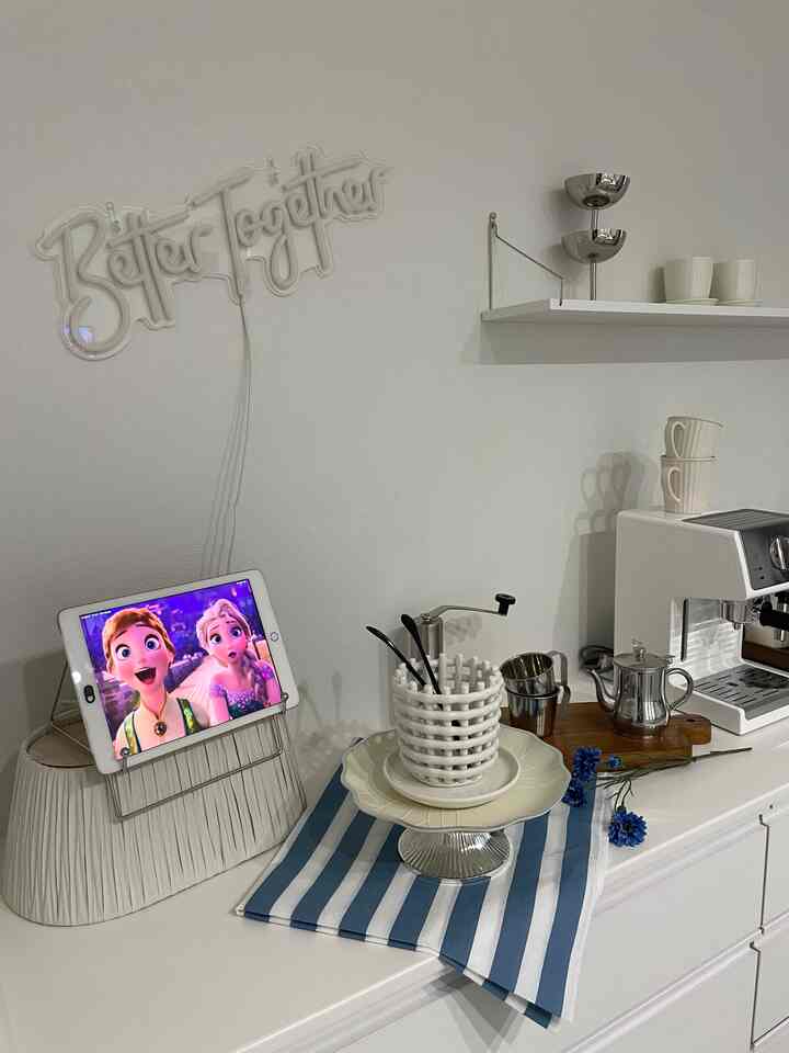 White and blue toned kitchen space featuring espresso machine and coffee tools creating a neat home cafe interior