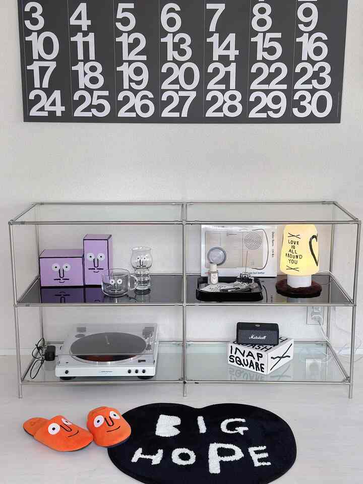 White and black toned balcony space featuring a transparent shelf with a turntable and diffuser, creating a modern and tidy atmosphere