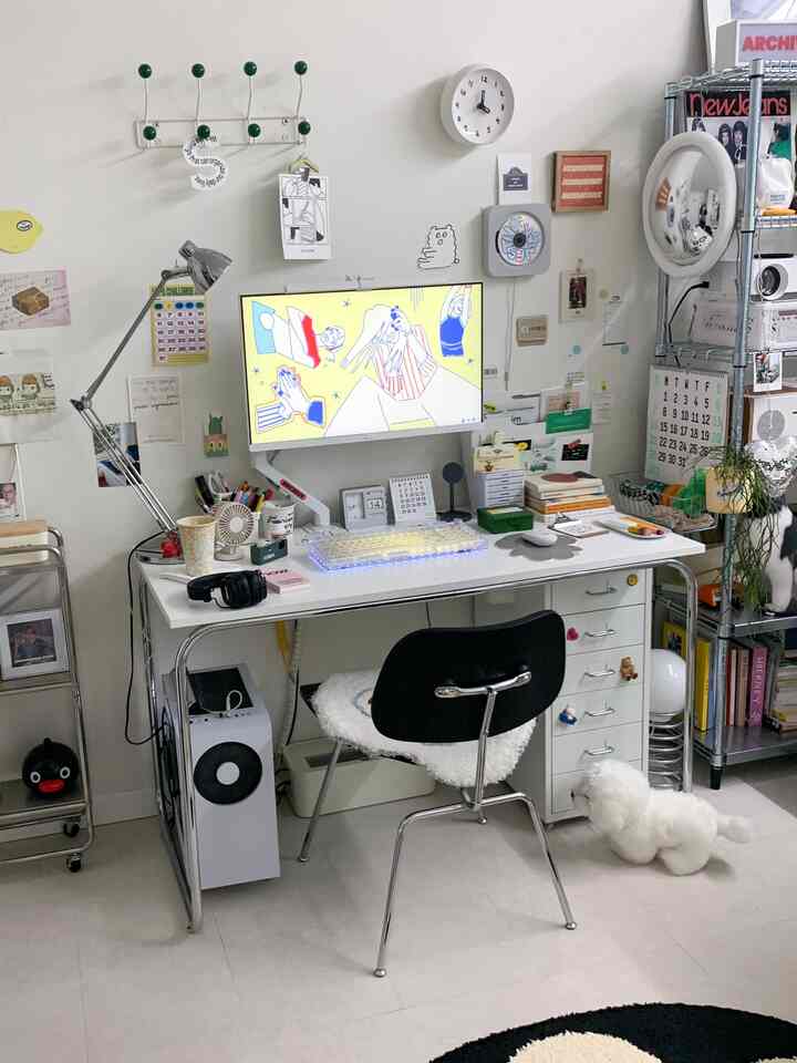 ホワイトトーンのコンパクトなワークスペース、ホワイトデスクにカラフルなキーボードとモニターが配置された清潔感のあるホームオフィス