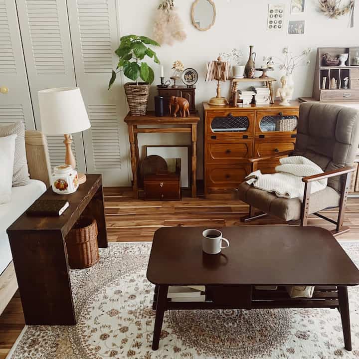 Beige and brown wood tone living room featuring vintage furniture and plants, creating a cozy atmosphere