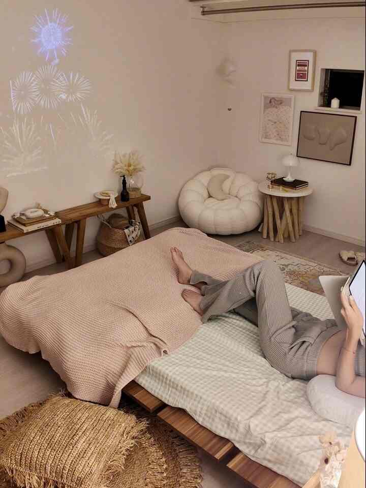 Natural-toned single household bedroom with soft beige bedding and wood tone furniture, featuring a cozy round armchair creating a calm atmosphere.