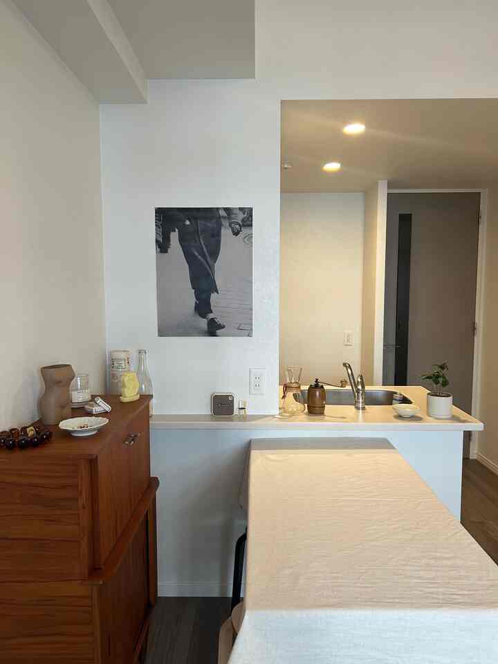 A cozy studio kitchen and dining area with beige and wood tones in a natural style