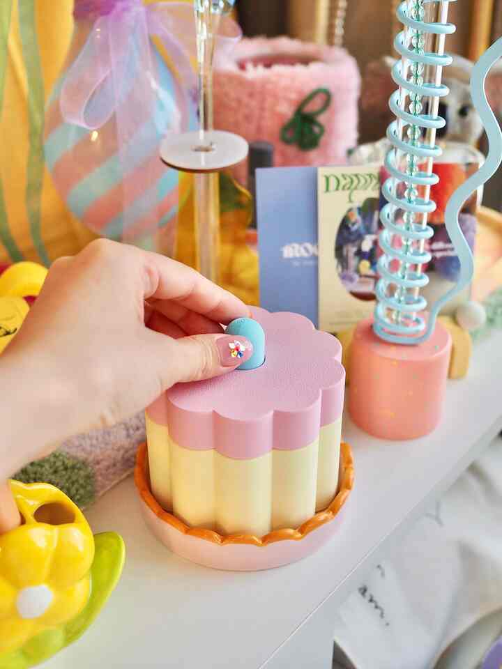 Pastel-toned charming small item storage and decorations arranged on a shelf in a cute interior space