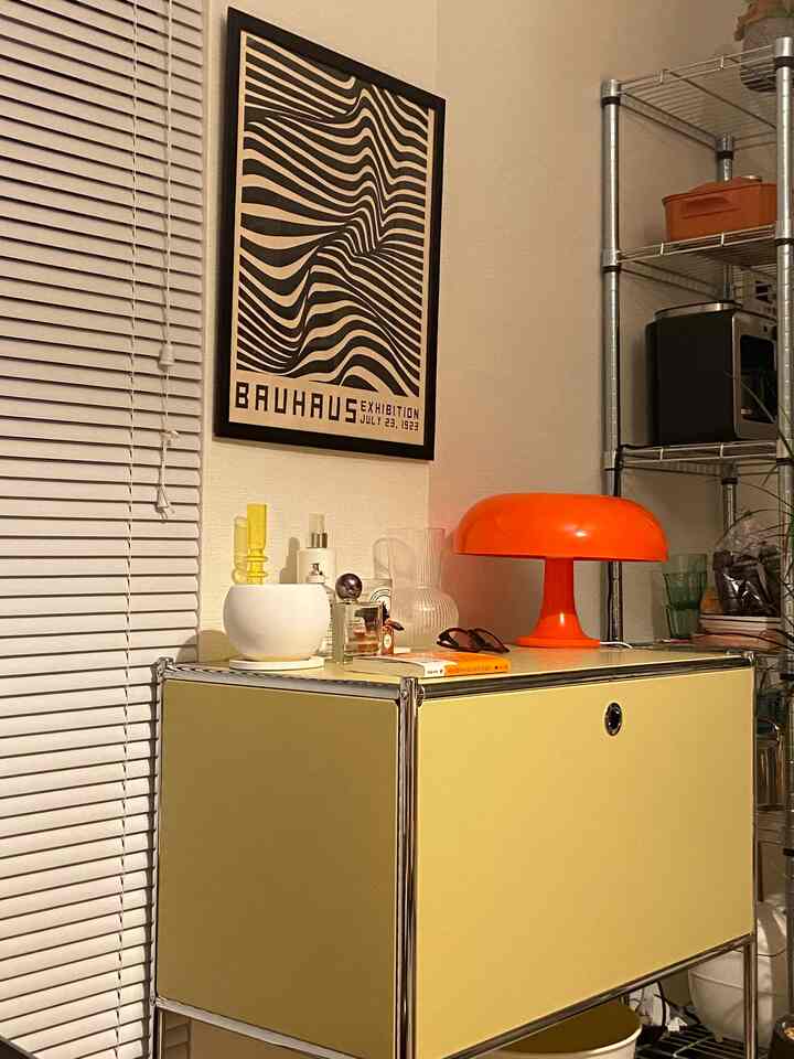Yellow storage rack and orange table lamp in mid-century modern living room space