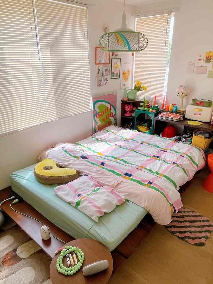 Mint and pink toned bedroom featuring IKEA bedding and retro decor creating a cozy atmosphere