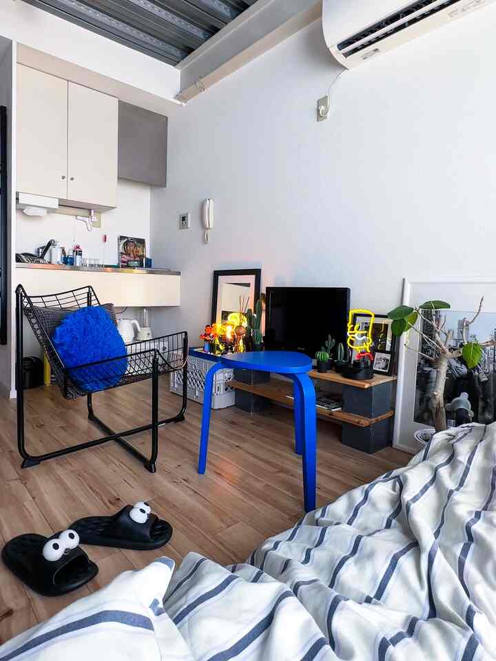 Bright blue stool with clean Nordic-style furniture in a compact single household living room space