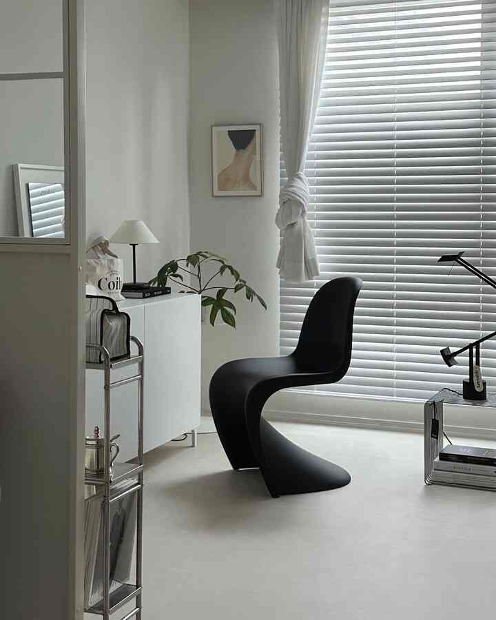 Monotone white and black modern study space featuring sleek furniture and lighting with a clean minimalist atmosphere