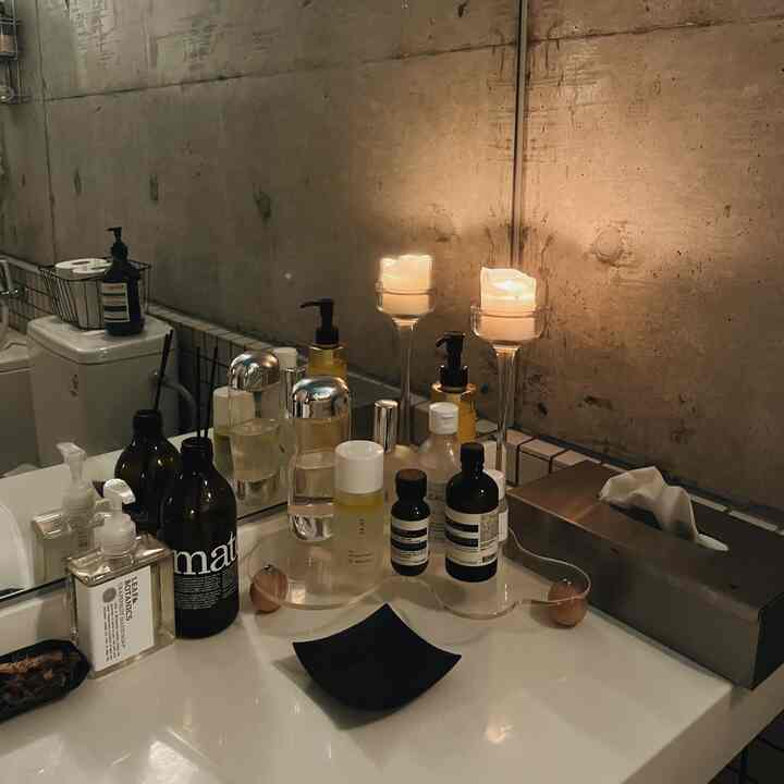 Natural toned bathroom vanity featuring candles and diffusers creating a cozy atmosphere