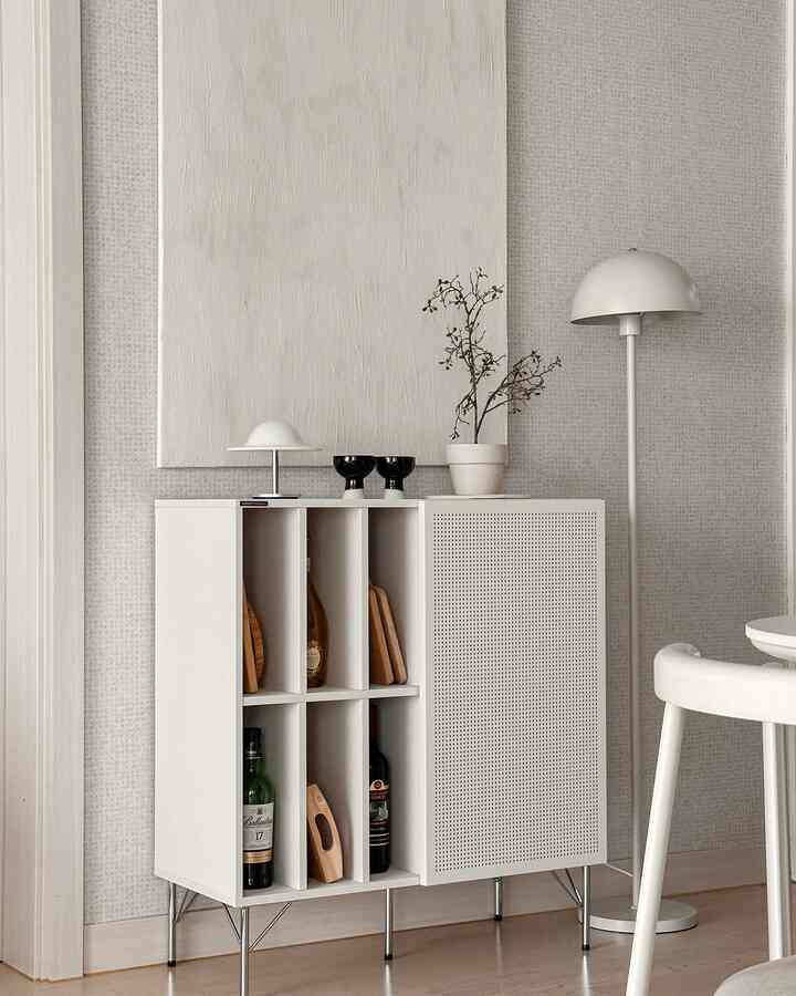 White and natural toned living room featuring a simple storage cabinet and floor lamp with a modern atmosphere