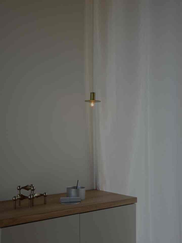 Ivory and wood tone entrance featuring pendant light and curtains with cozy atmosphere