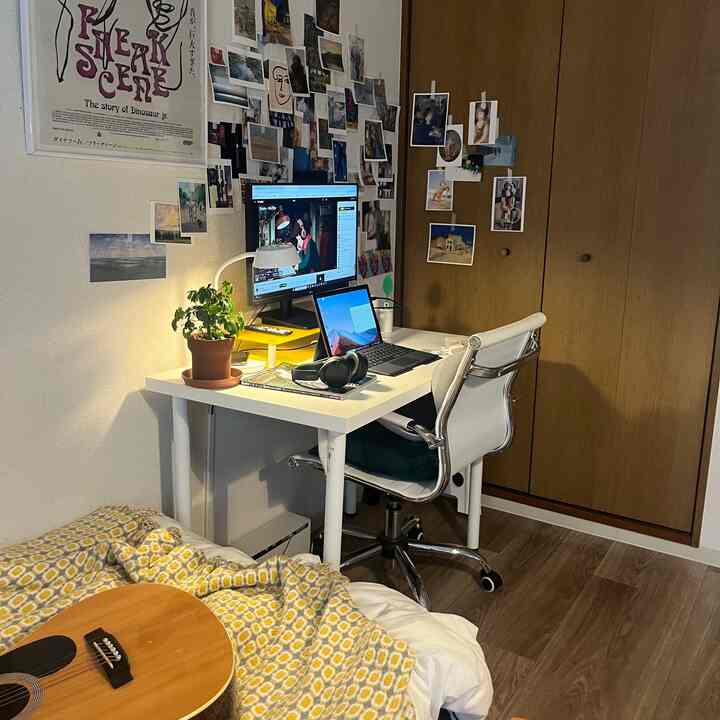 White and wood-tone 8-tatami 1K studio home office with wall decor and desk creating a cozy atmosphere