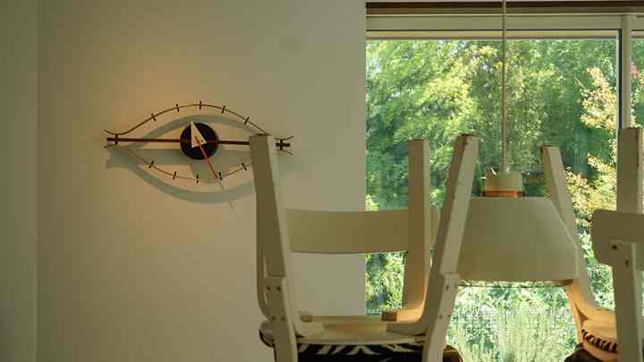 白を基調とした北欧風ダイニング、アルテックの椅子とヴィトラのアイクロック、ペンダントライトが配置された印象的な空間