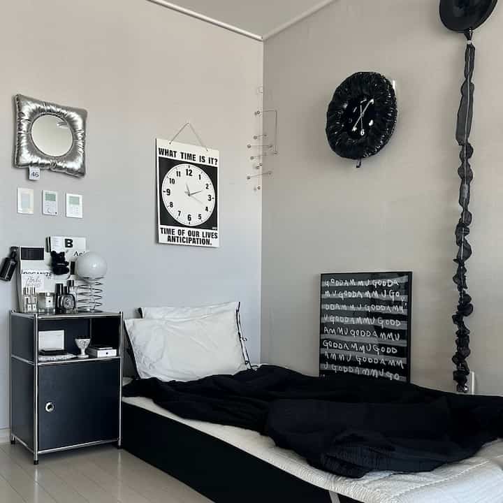 Gray-toned walls and black bed with nightstand in a modern, simple bedroom space