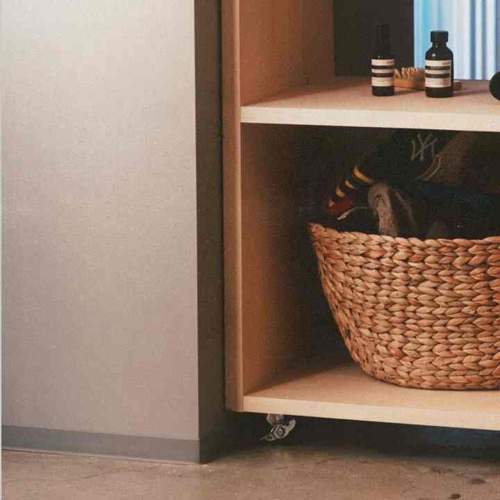 Beige-toned shelf and basket in an entrance or small storage space showcasing a natural, warm interior