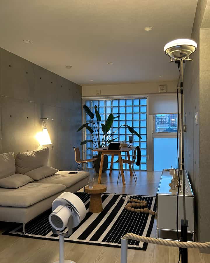 Natural-toned living room featuring a sectional sofa and wood dining set with cozy modern ambiance