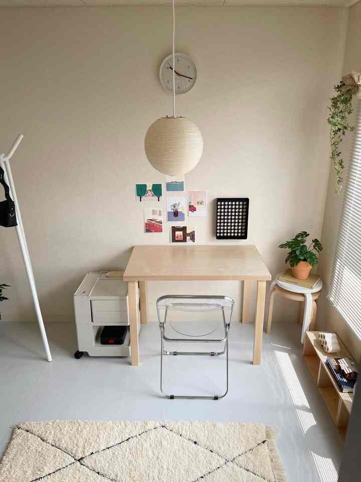 Bright wood-tone desk with transparent chair in a simple, natural workspace space