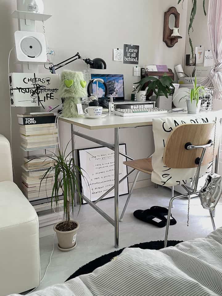 Bright white-toned home office featuring a wooden chair and multiple plants, creating a cozy workspace decoration